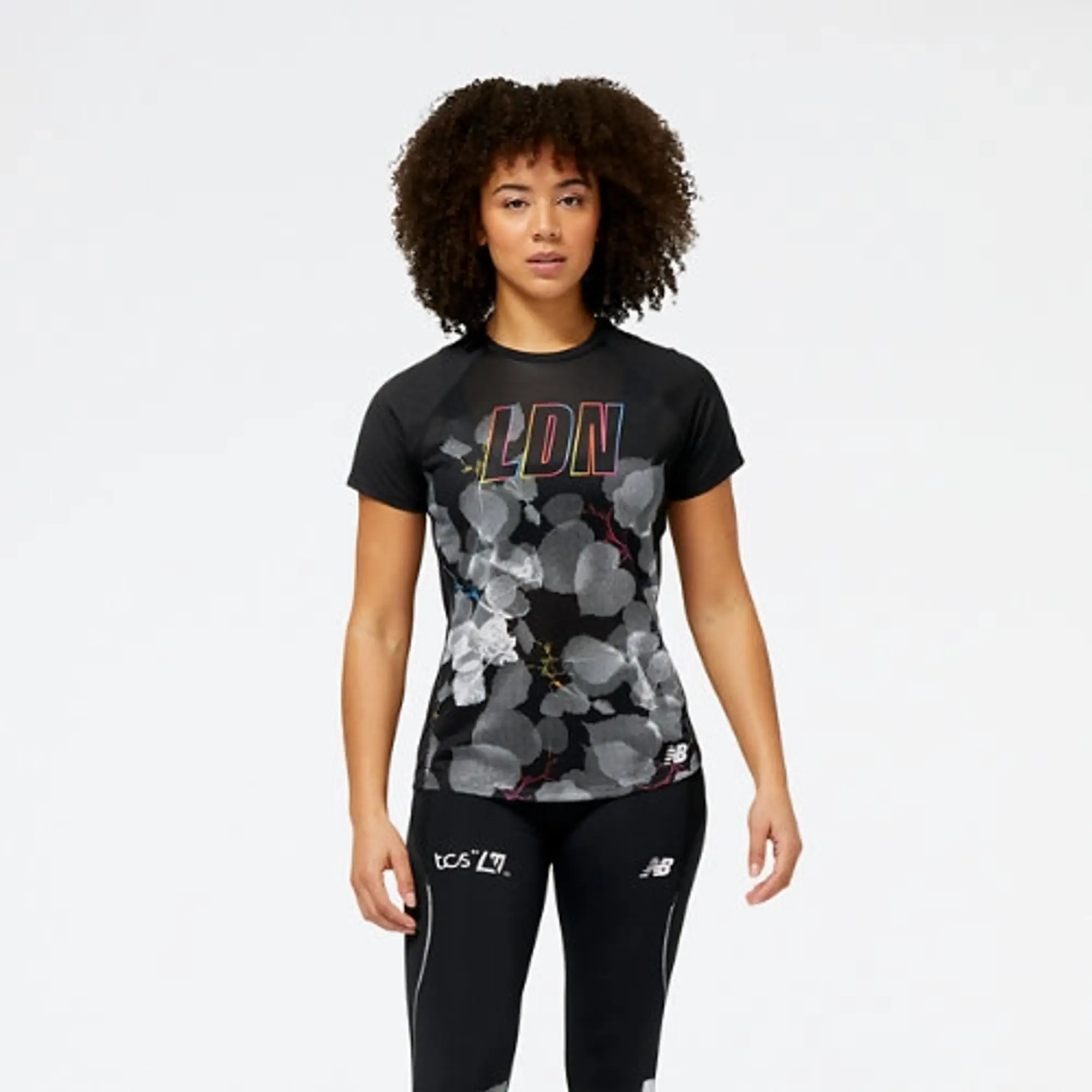 New Balance Women's London Edition Printed Impact Run Short Sleeve in Black Poly Knit