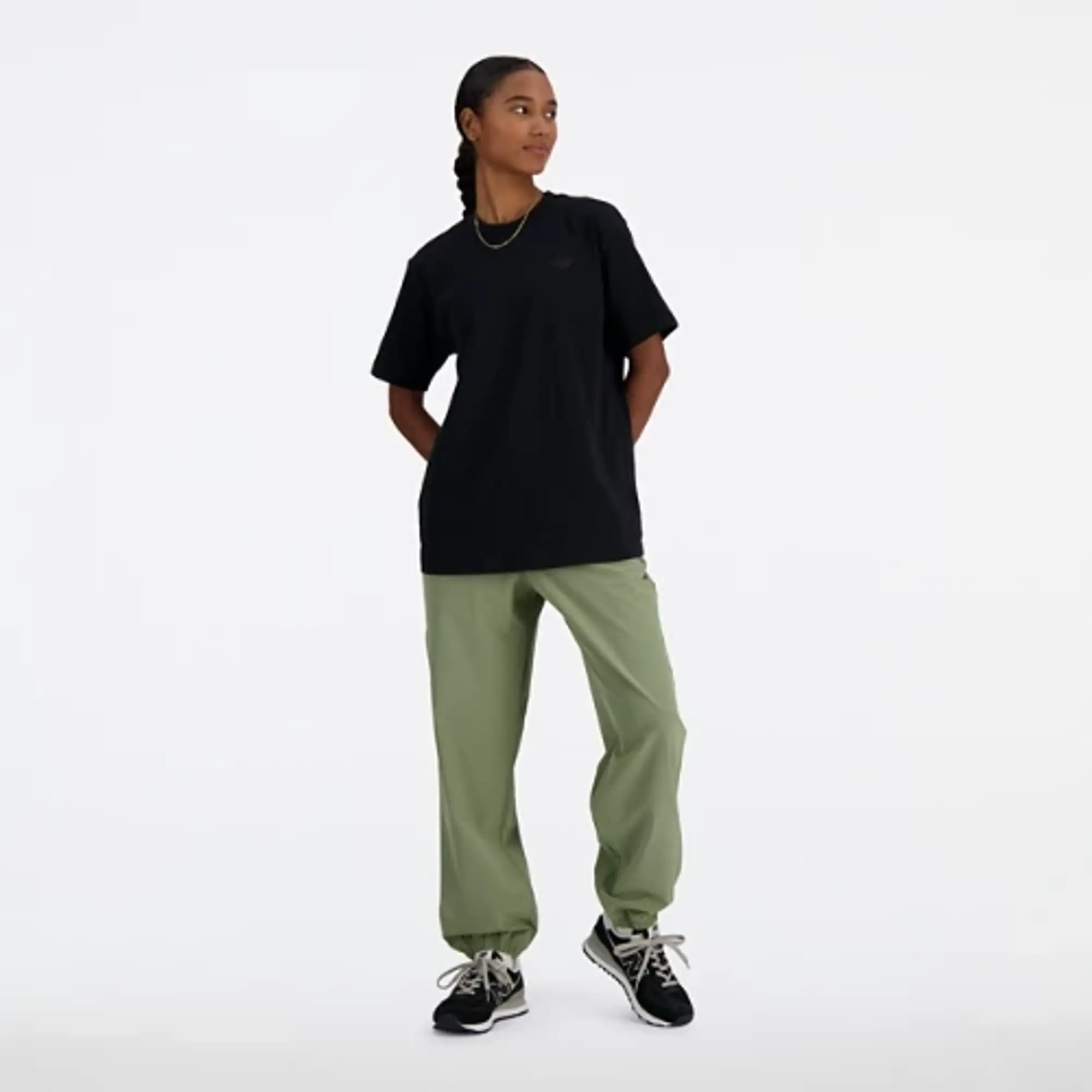 New Balance Women's Athletics Stretch Woven Jogger in Green Poly Knit