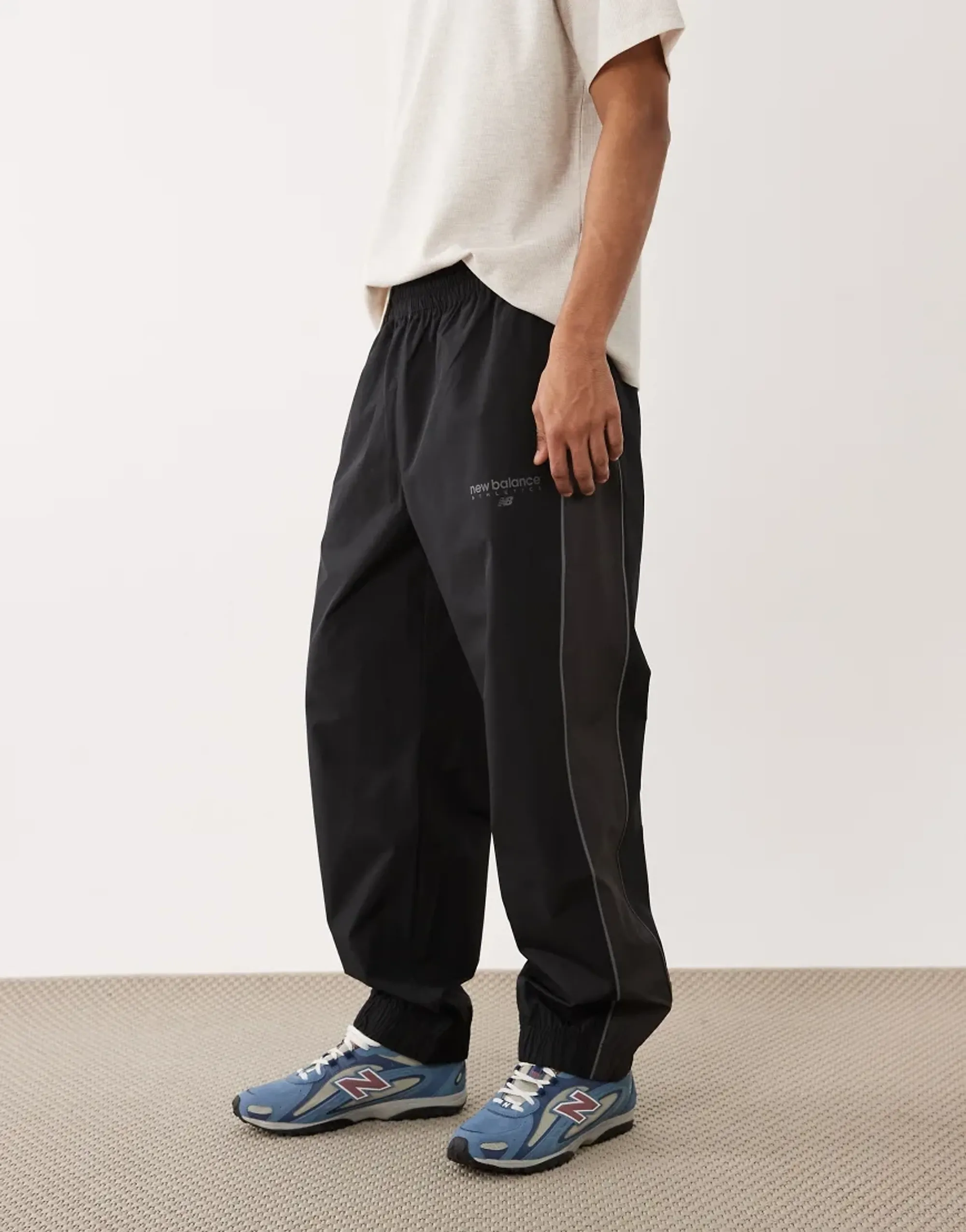 New Balance Men's Trackside Woven Pant in Black/White Polywoven
